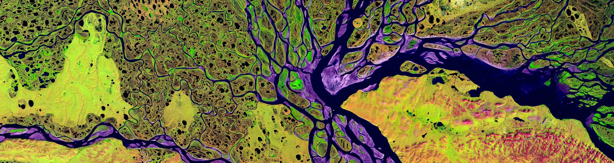 Satellite photo of a colourful river delta